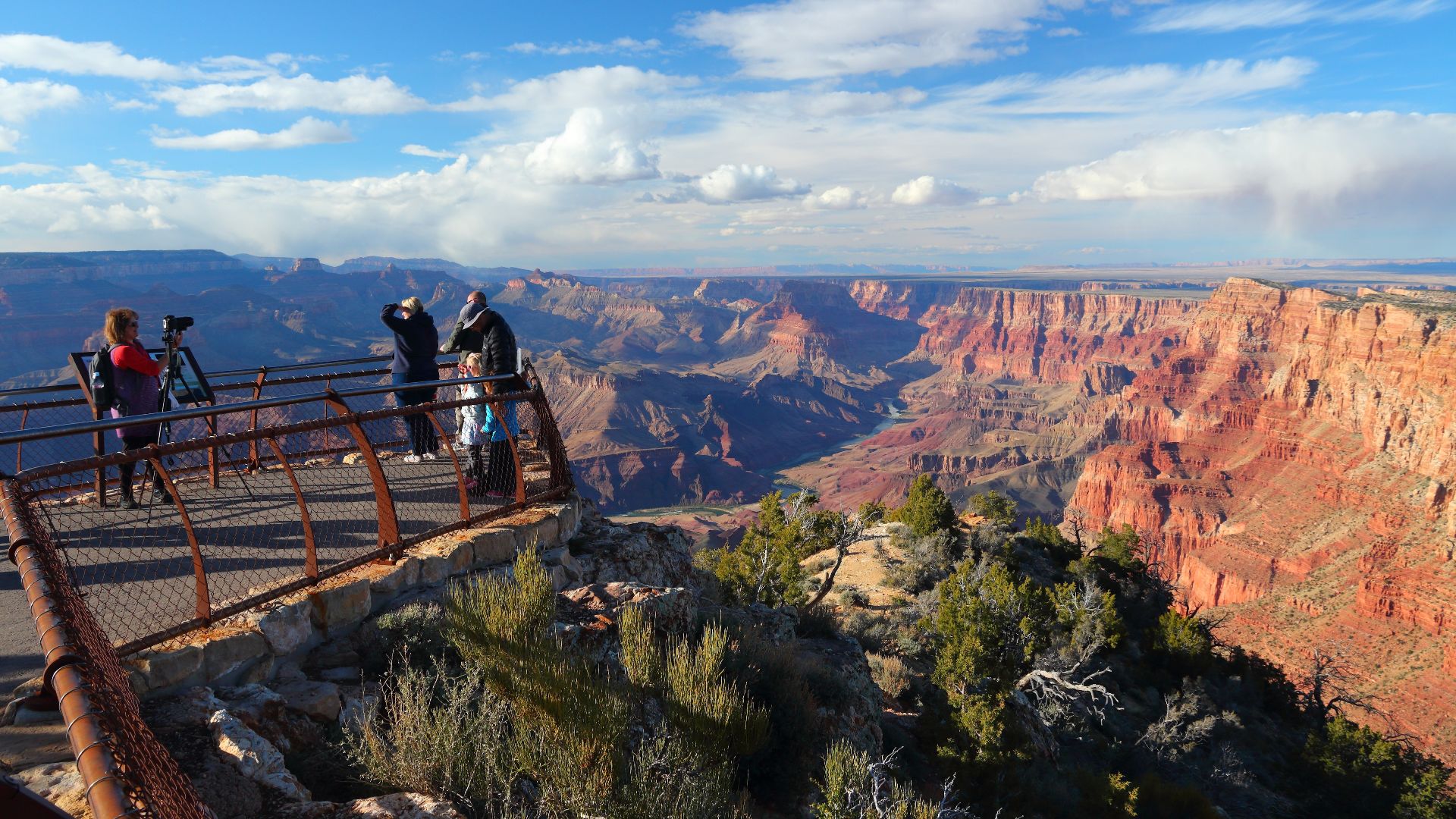 American nature. Tourists at Grand Canyon Navajo Point viewpoint terrace, Grand Canyon National Park, Arizona, USA. Late afternoon light at South Rim of Gran Canyon.