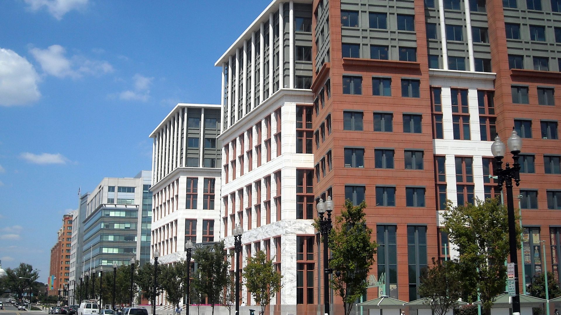 The United States Department of Transportation headquarters, located at 1200 New Jersey Avenue, S.E., in the Navy Yard neighborhood of Washington, D.C.  The dome of the United States Capitol is visible in the background.