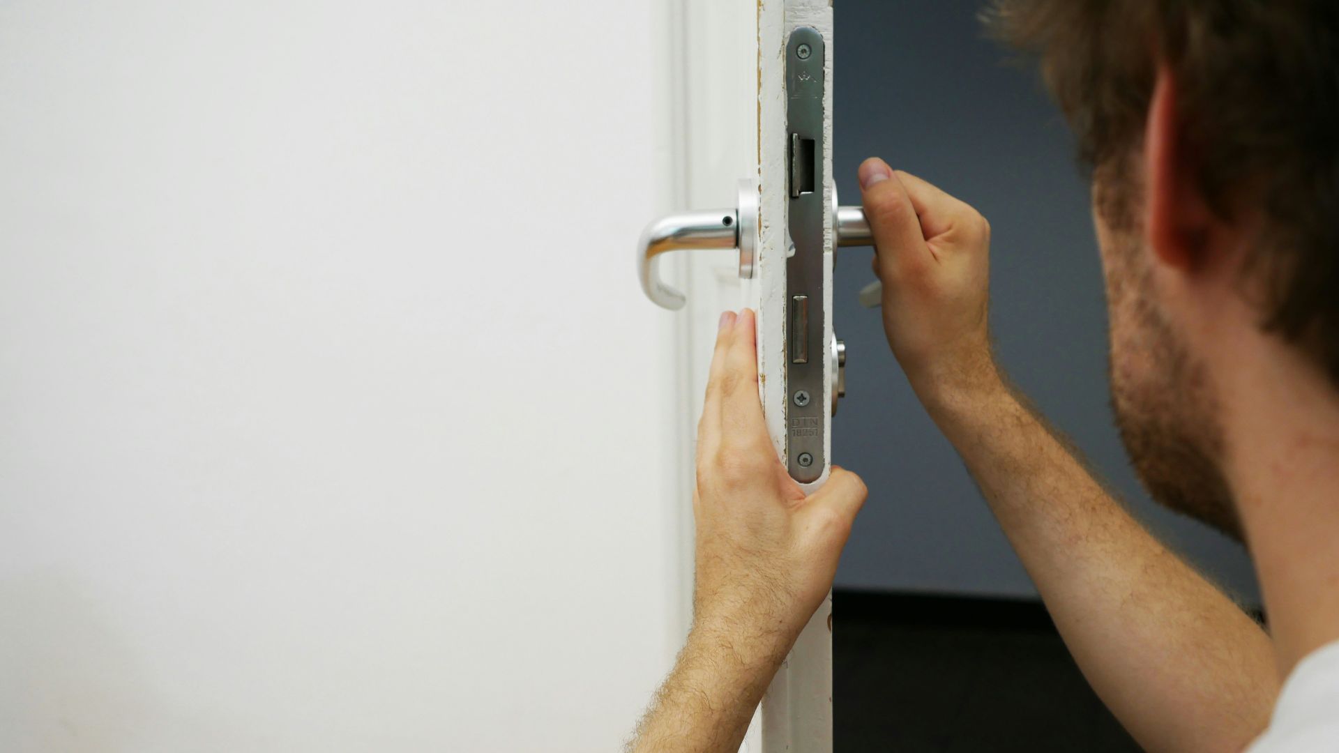 person holds door lever