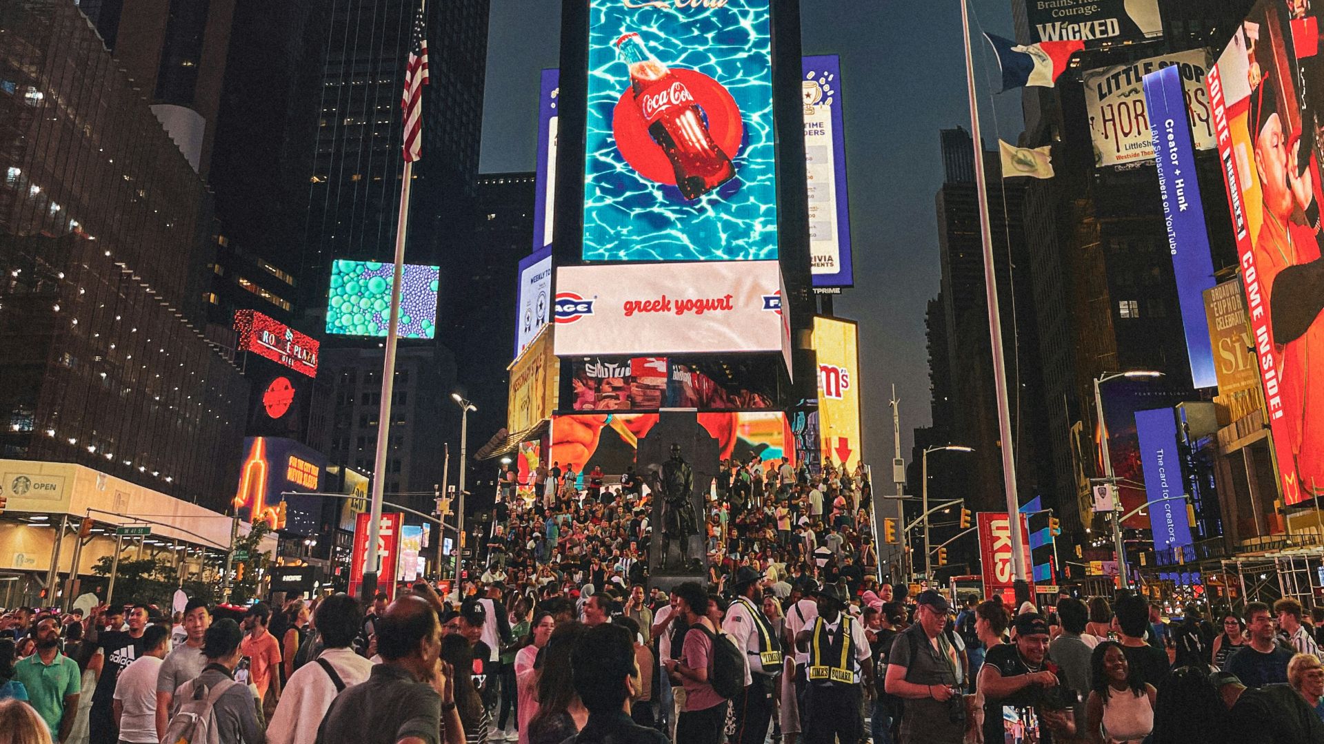 A crowded city street filled with lots of people