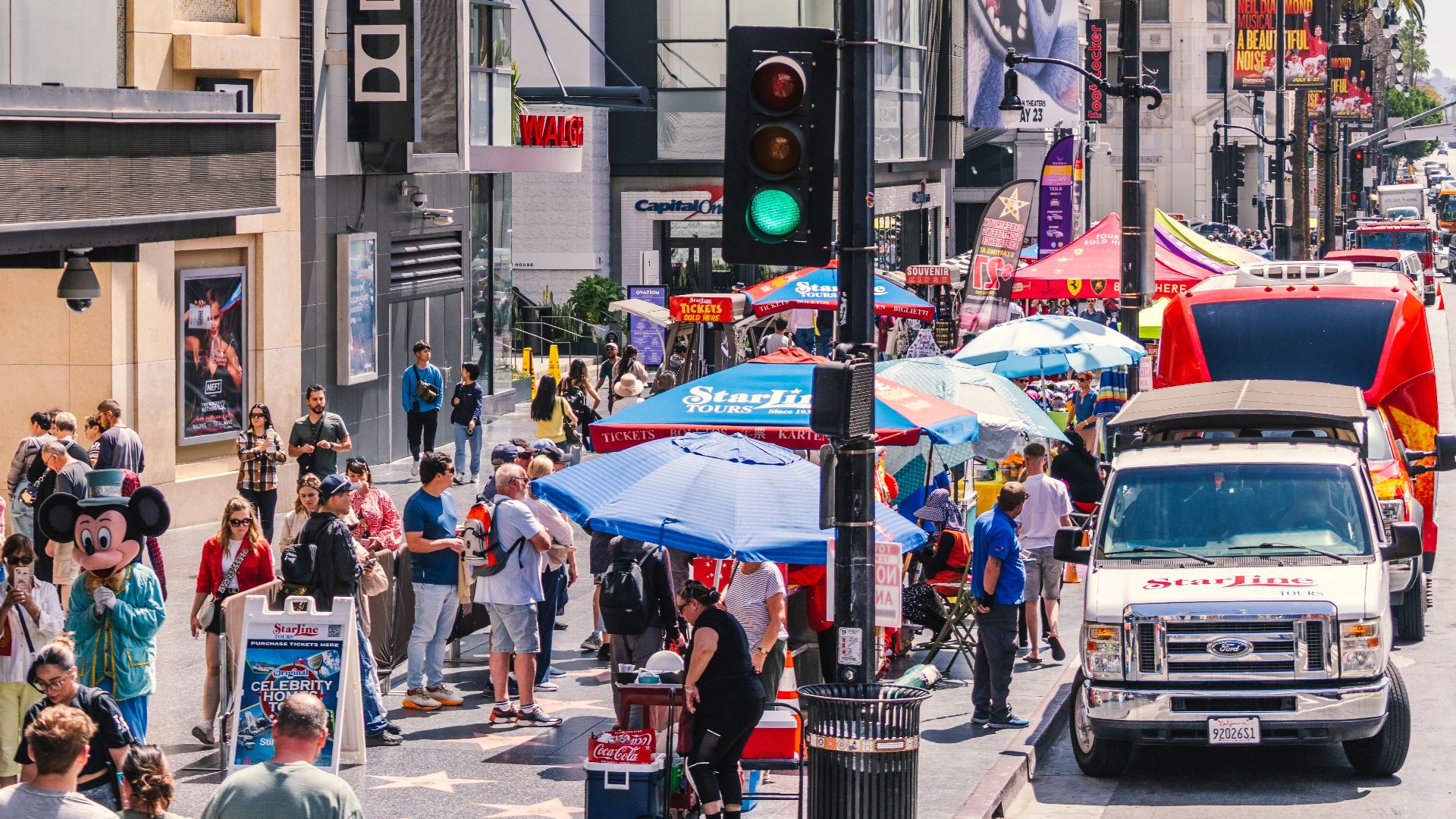 Vibrant scene of Hollywood Boulevard with crowds, shops, and iconic Dolby Theatre in Los Angeles.