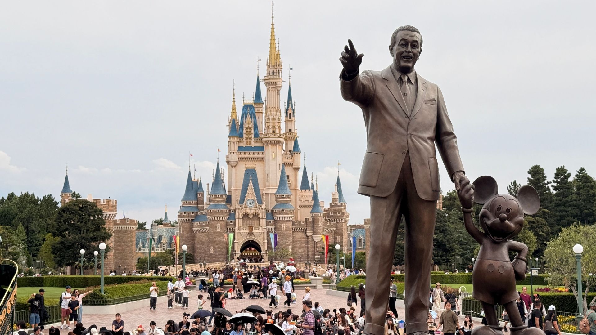 Statue of Walt Disney and Mickey Mouse in front of Cinderella Castle, Tokyo Disneyland.
