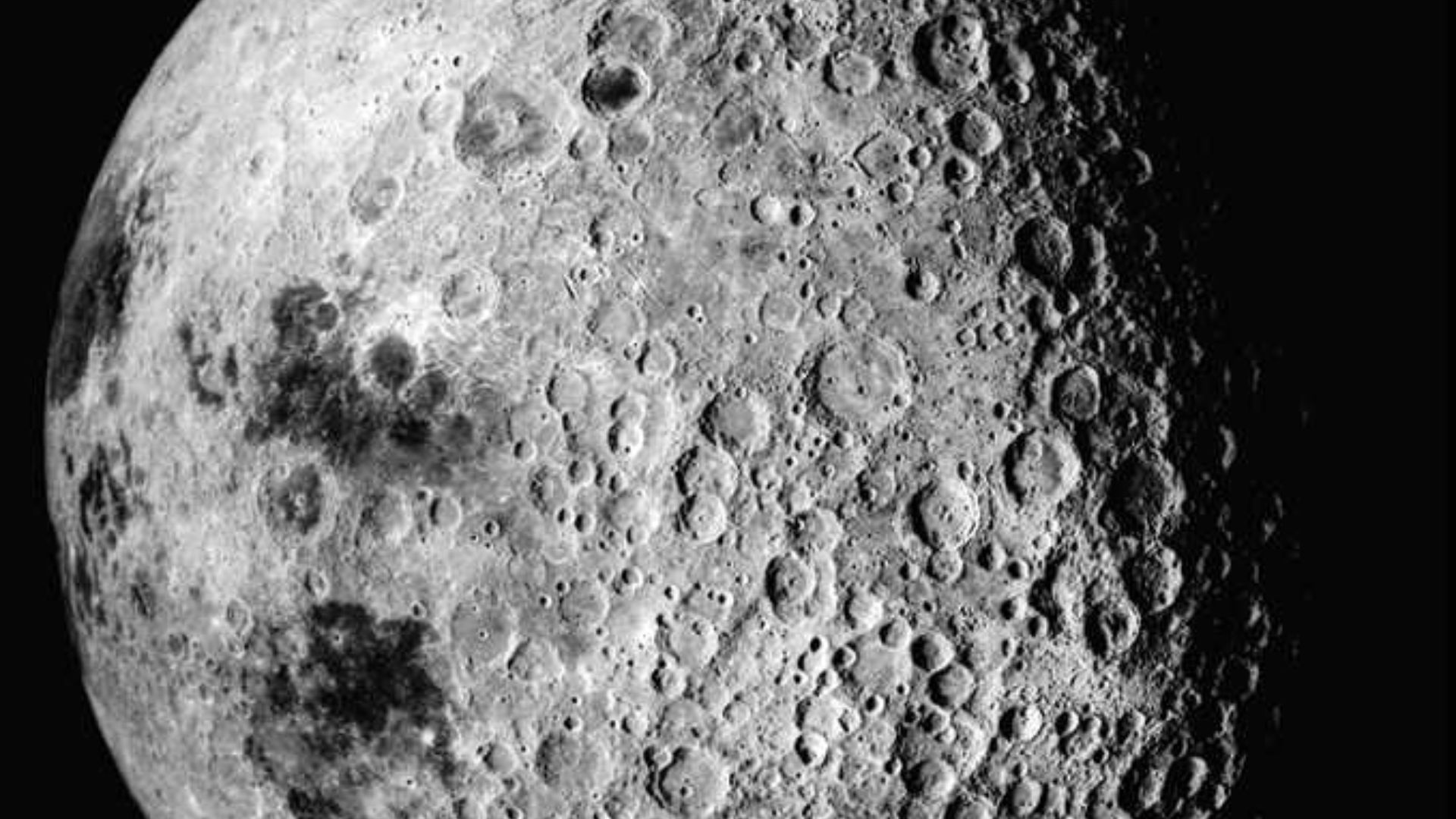 The far side of the moon. This side is more exposed to meteoroids than the near side, and thus is more cratered.