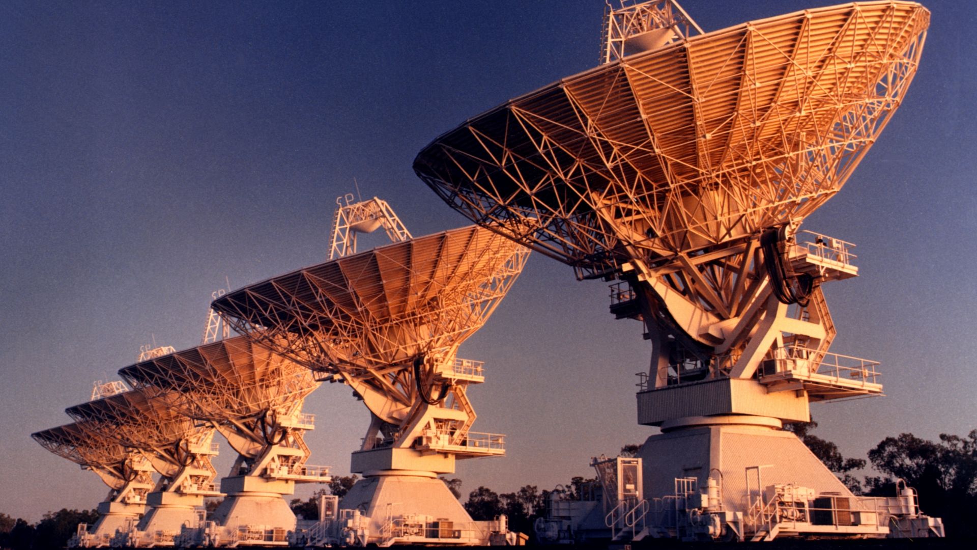 Five antennas of the Australia Telescope Compact Array, near Narrabri (New South Wales). This photograph was taken in the late phase of the construction process (~1984).