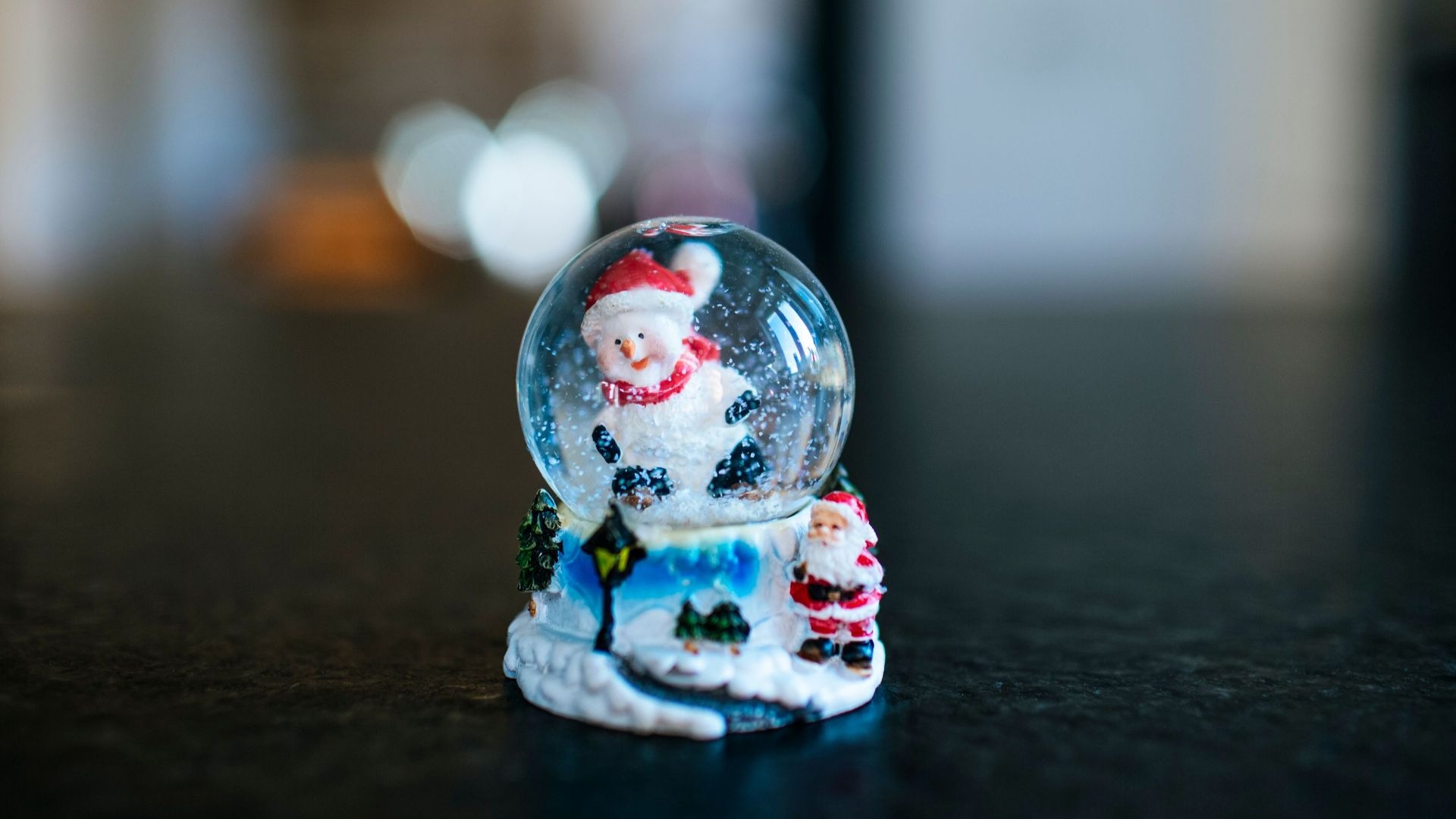 Close-up of a Christmas snow globe featuring a Santa Claus figurine, perfect for holiday decor.