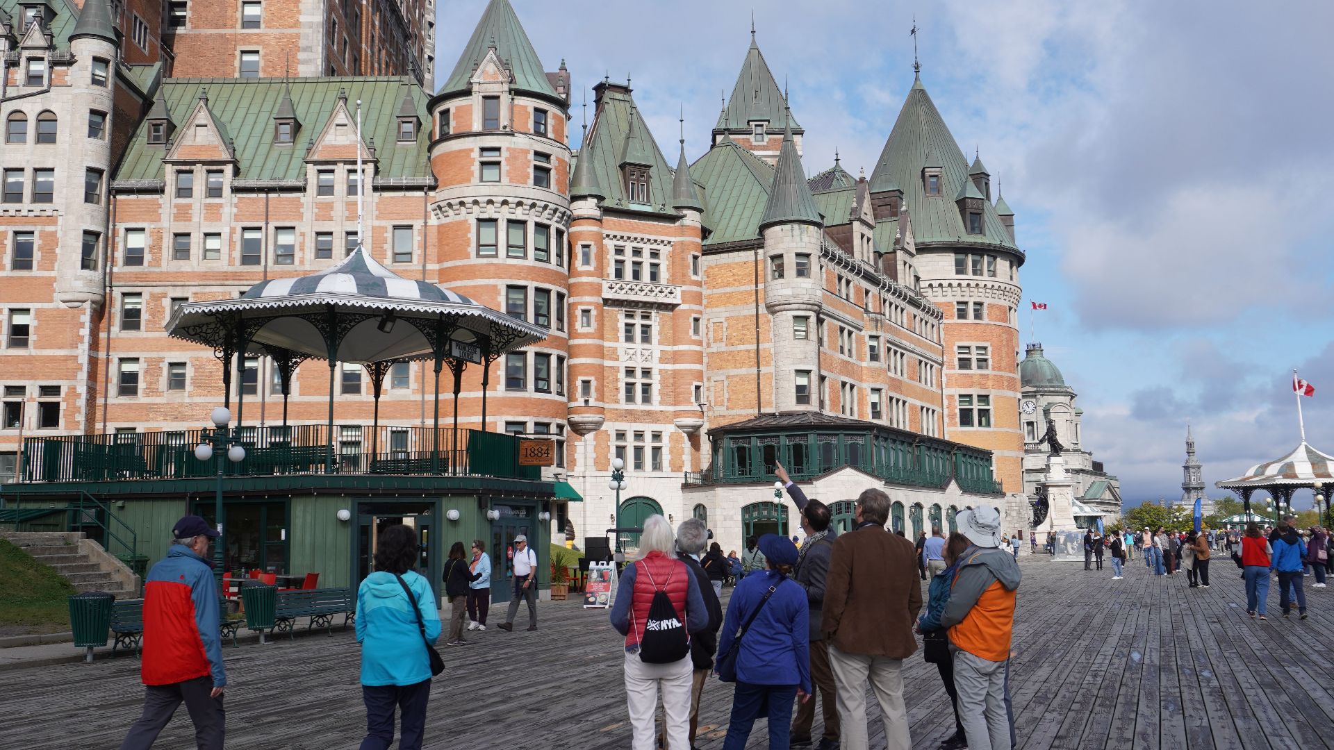Visitors admire the iconic Château Frontenac on a clear day in Quebec City, Canada.