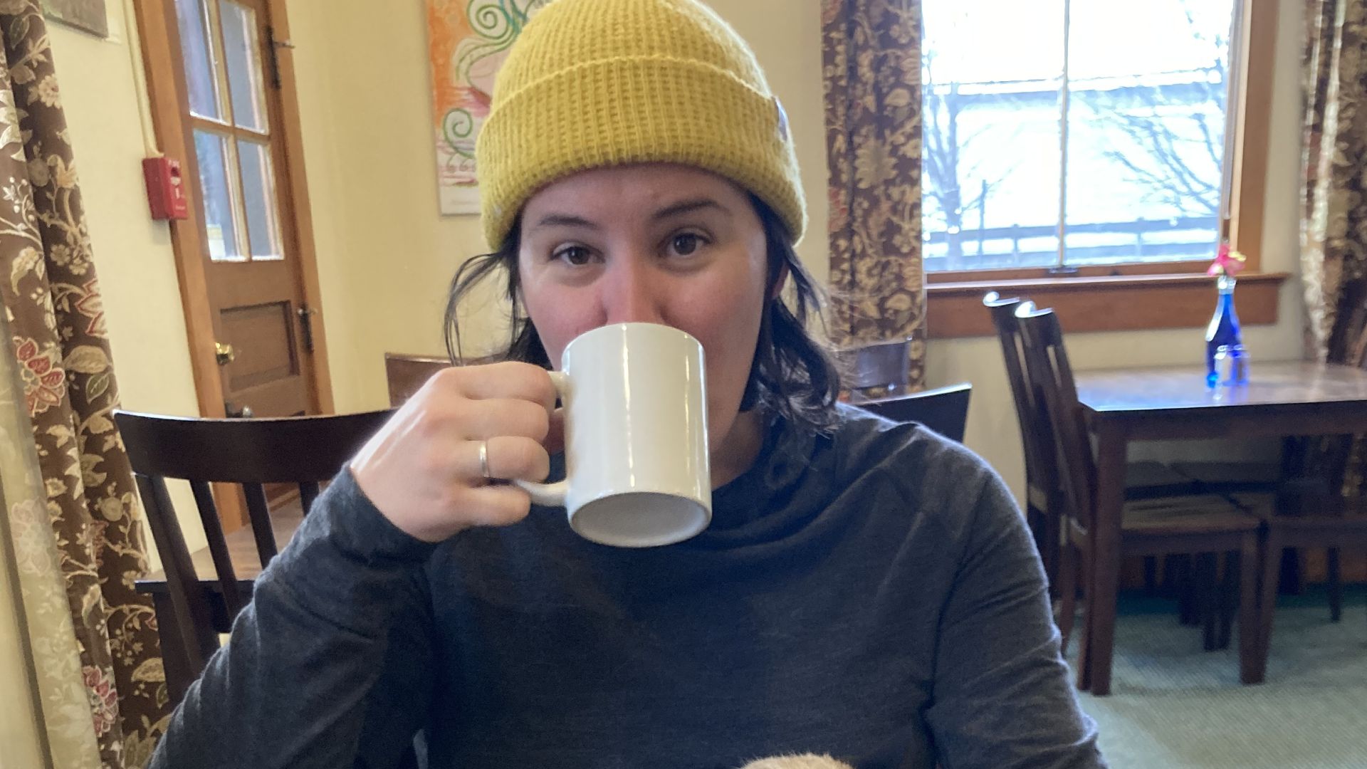 A guest eats breakfast with the hotel cat at the Balch Hotel in Dufur, Oregon