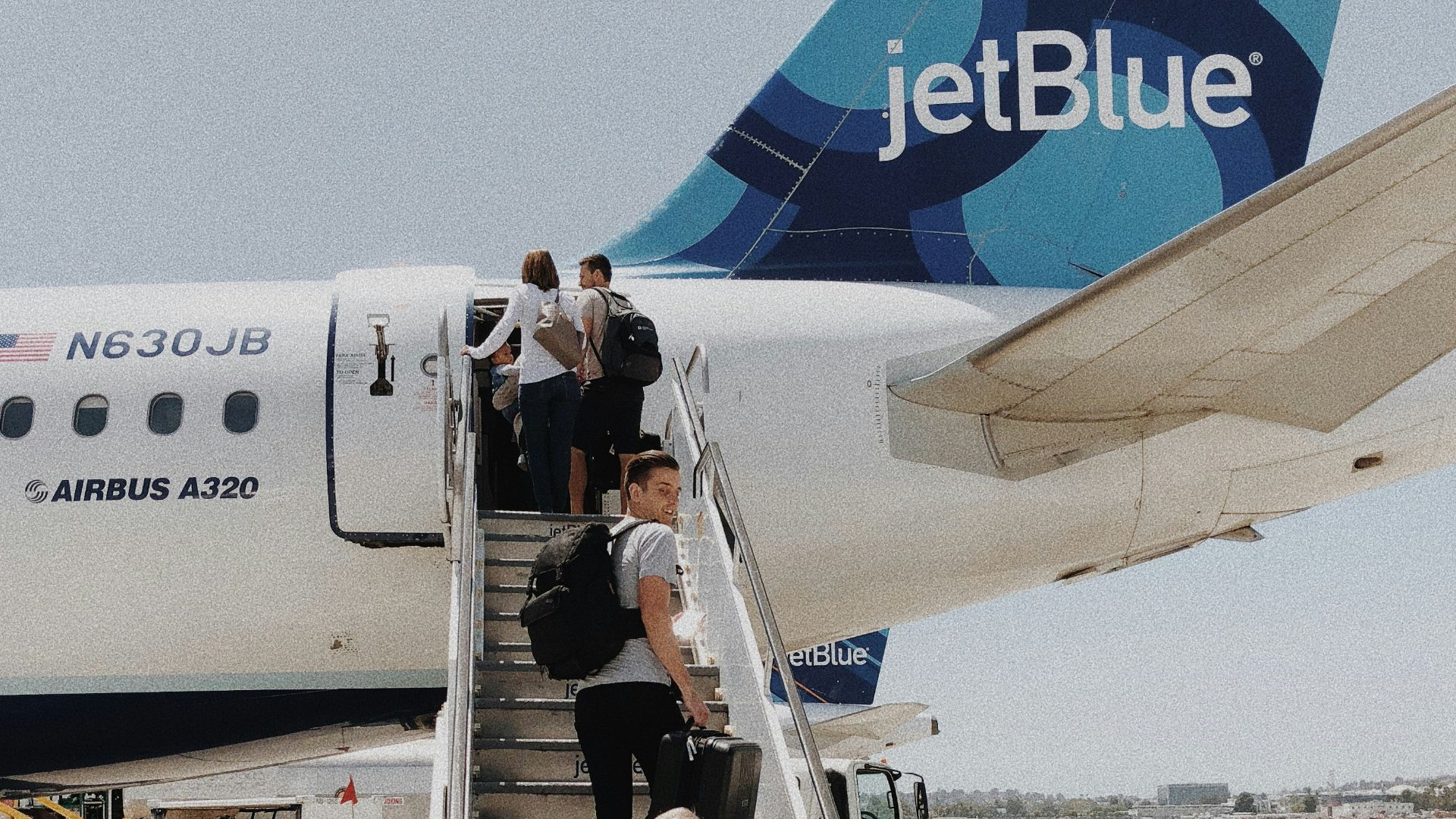 people walking on plane stair during daytime