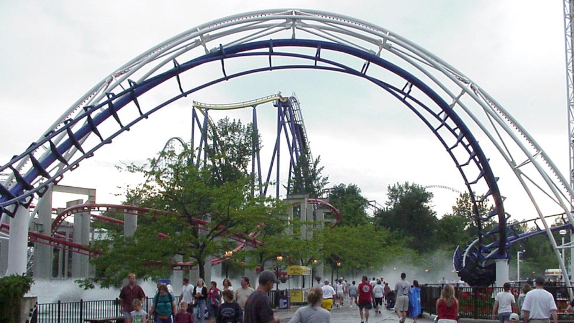 Coasters inside the Cedar Point amusement park in Sandusky, Ohio

Top to bottom: The Corkscrew (overhead), The Mantis (yellow track), The Millennium Force (in distant background), and The Iron Dragon (red track). The Power Tower runs along the right side 