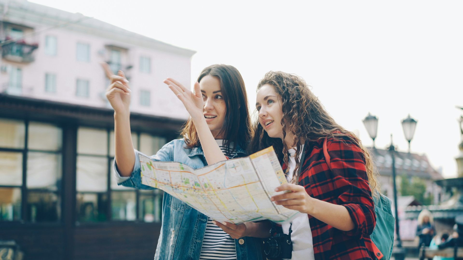 Two women use a map to find directions.