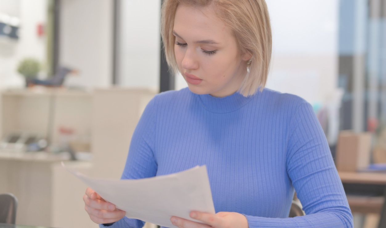 Young Woman Reading Documents at Work