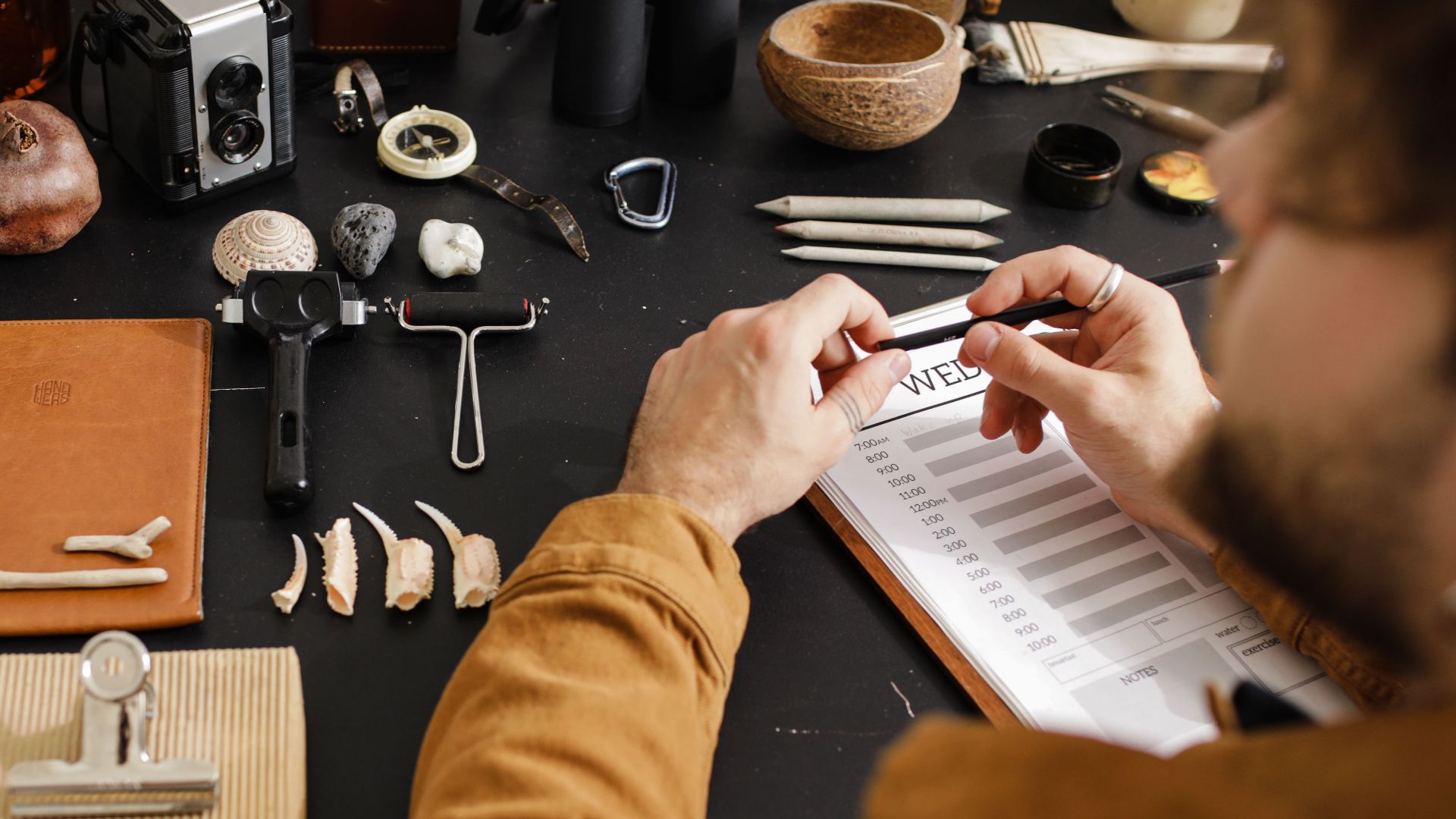 An archaeologist meticulously studies various fossils, highlighting detailed research and examination.
