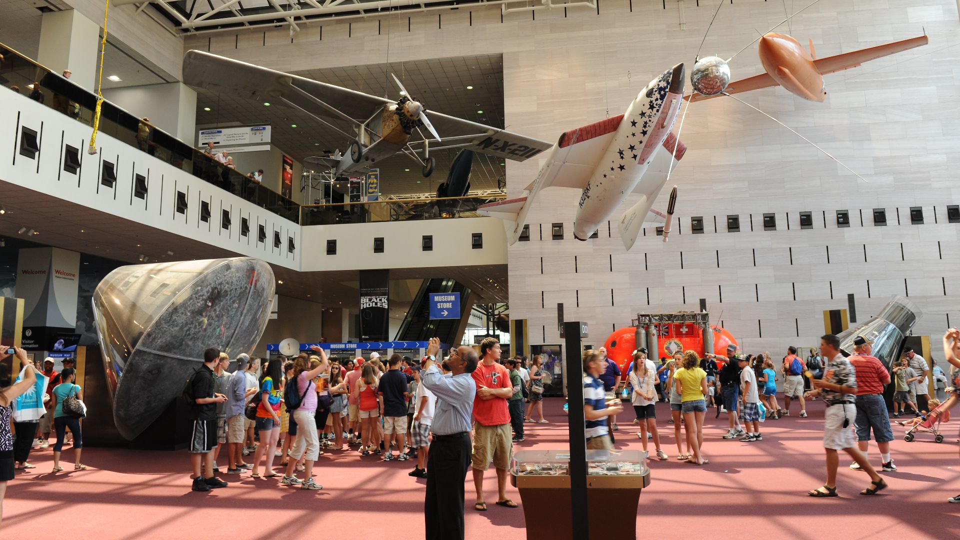 The entrance hall of the National Air and Space Museum in Washington, DC. Among the visible aircraft are Spirit of The St. Louis, the Apollo 11 command module, Space Ship One, and X-1.