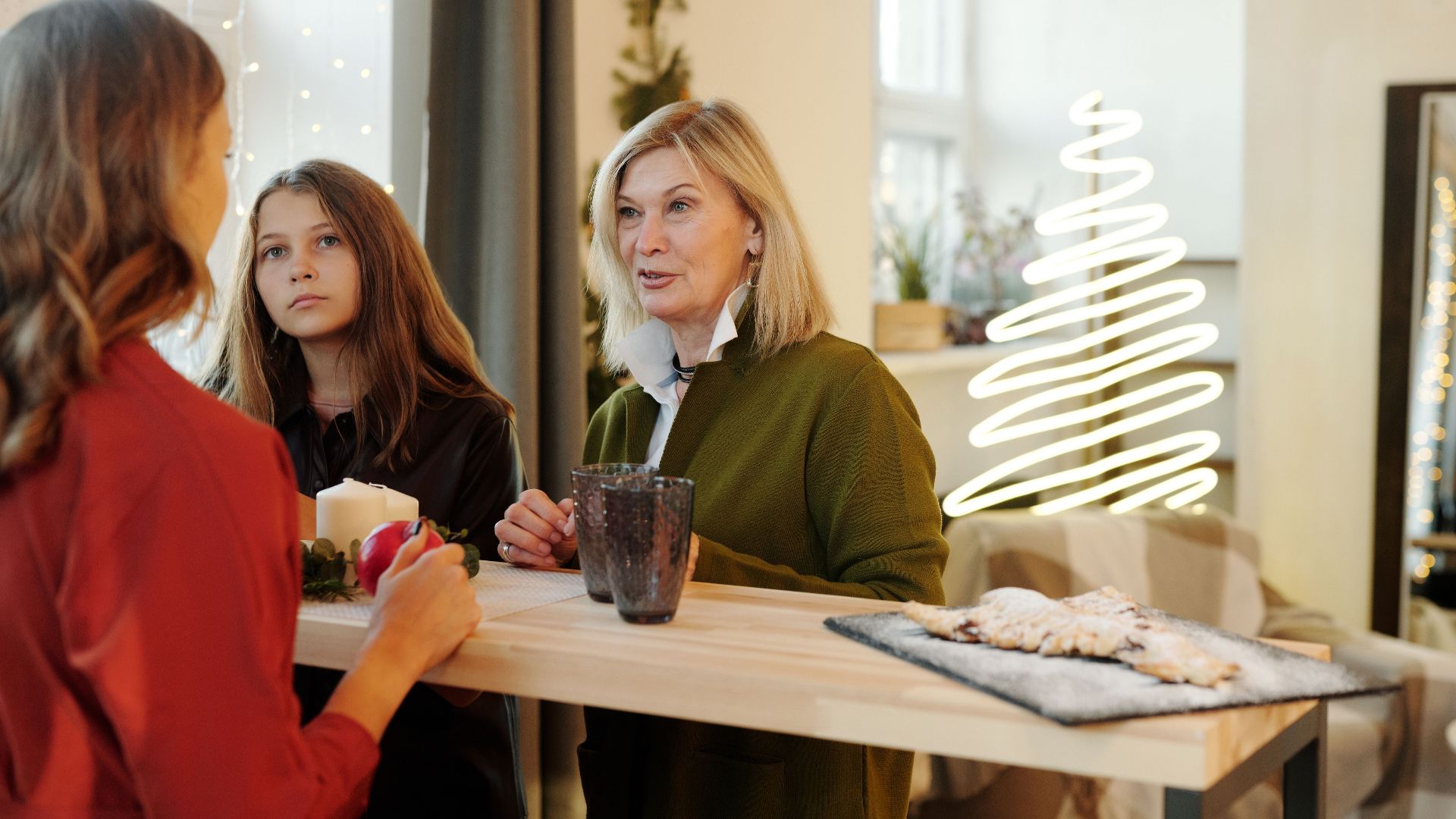 Family enjoying Christmas preparations in a cozy, decorated living room.