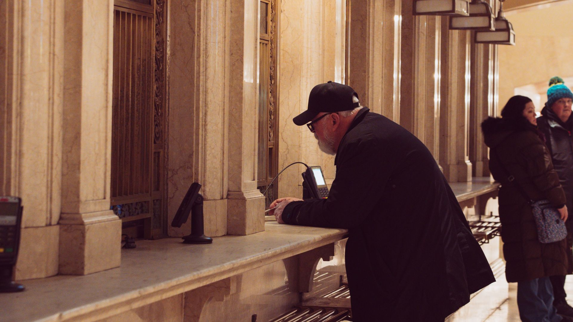 People at a vintage ticket counter in Grand Central Terminal, New York City.