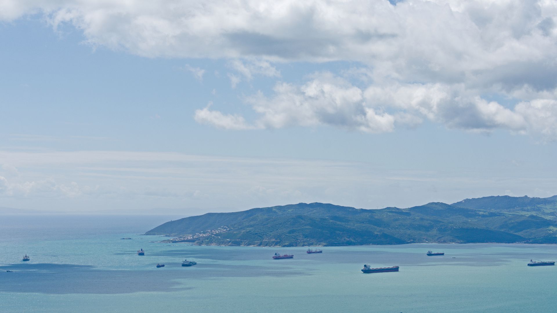 View of Punta Carnero from Spur Battery Road, Gibraltar. Strait of Gibraltar and little islands/rocks near the coast. Ships in the Bay of Gibraltar.