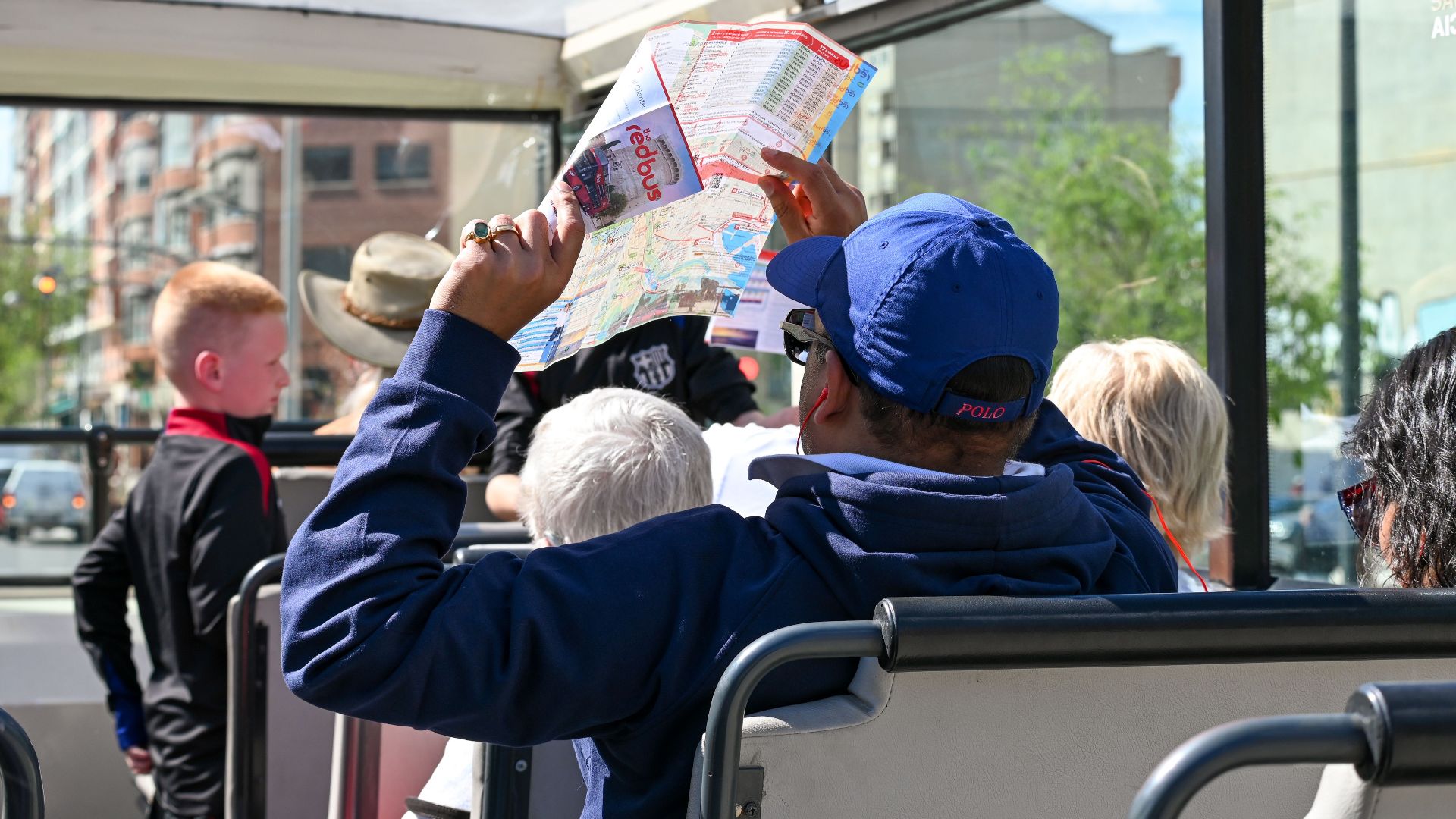 Tourists explore Valencia on an open-top bus tour, highlighting city sights and attractions.