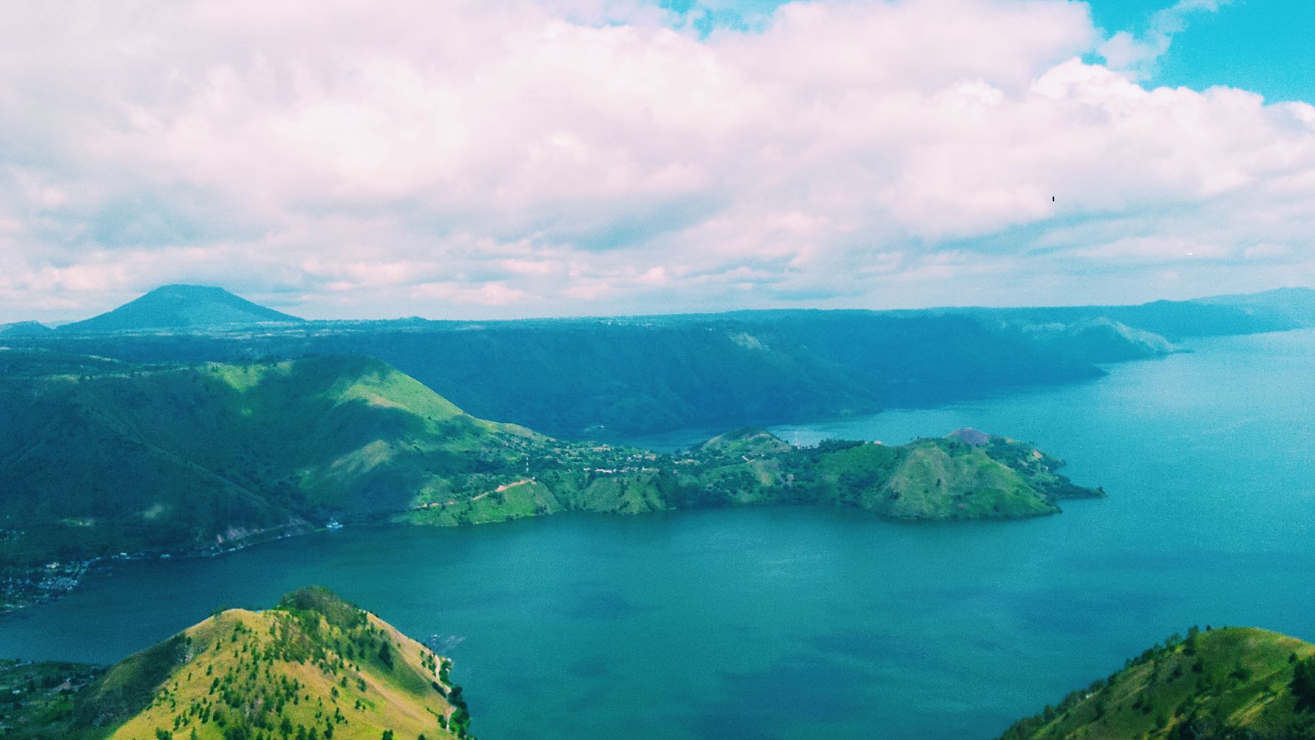 The large eruption of Mount Toba that occurred 3 (three) times. First time, it was about 900,000 years ago, second time 500,000 years ago and third time 75,000 years ago and creating a large caldera. This caldera then filled with water and eventually beca