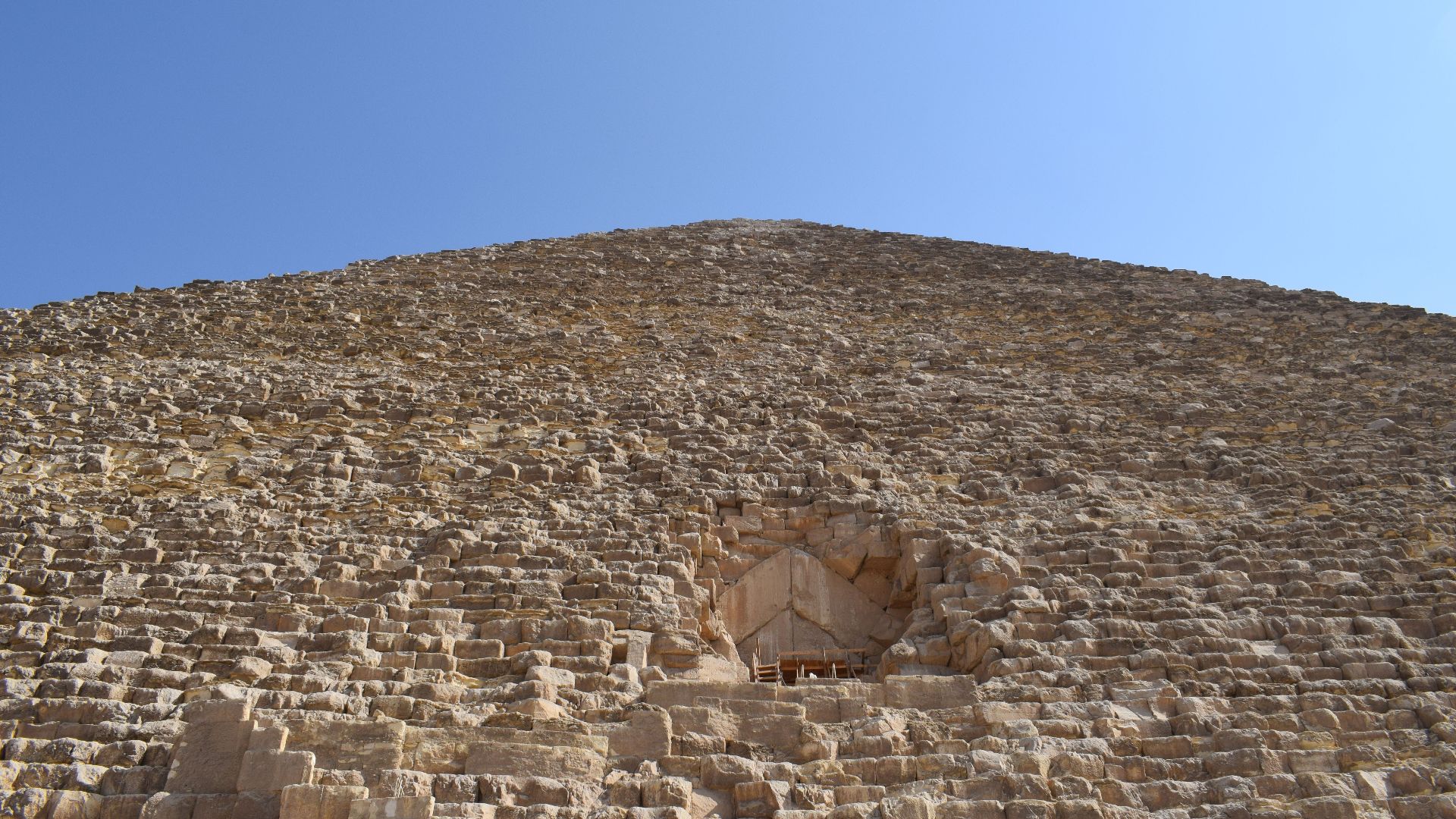 Close-up image of the Great Pyramid of Giza, showcasing its ancient architecture under a clear sky.