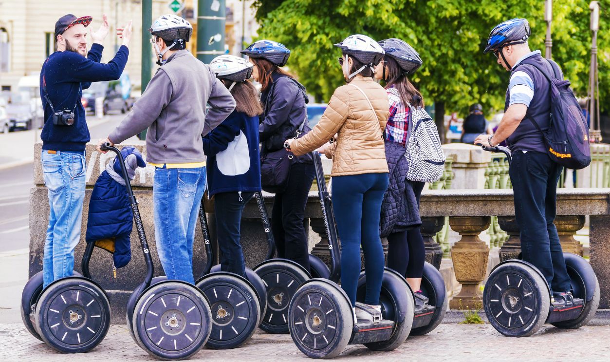 CZECH REPUBLIC, PRAGUE - MAY 21, 2016:a tour guide leads a group of tourists traveling on the Segway through the streets of Prague