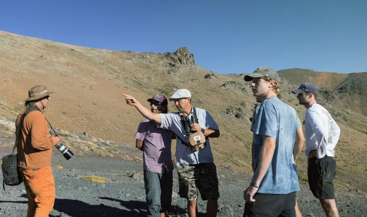 a group of people standing on a hill