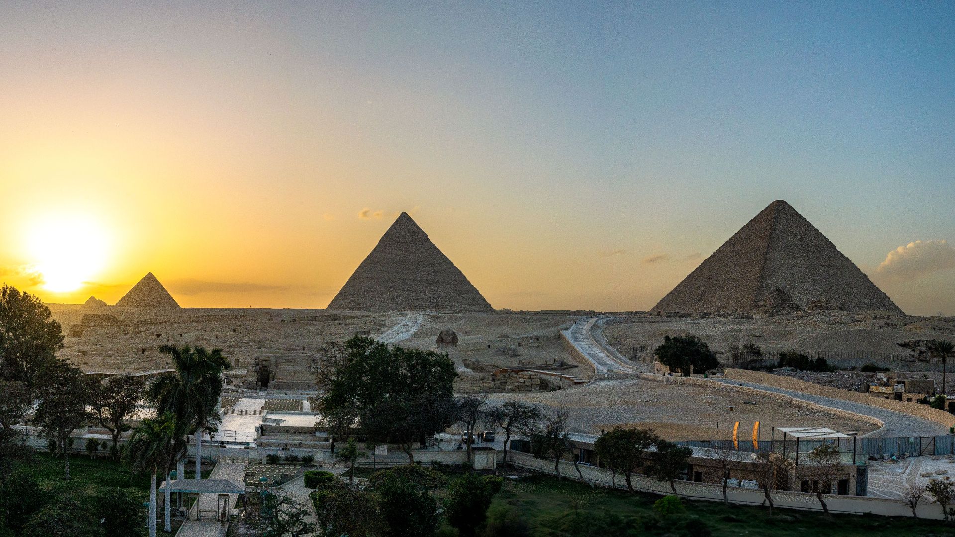 Breathtaking view of the Pyramids of Giza at sunset, capturing ancient history and stunning landscape.