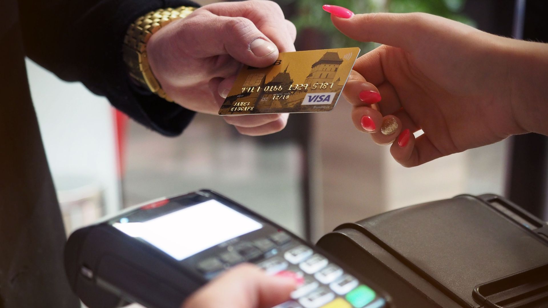 Close-up of a credit card payment being processed at a POS terminal.
