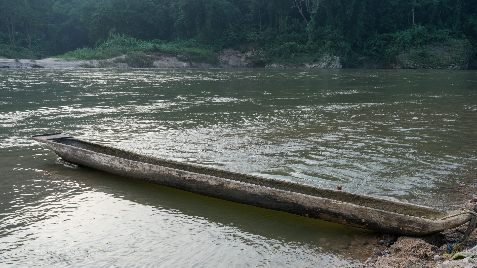 Full view starboard side. Dugout canoe moored on the right bank of the Simsang River, Siju, South Garo Hills, Meghalaya, India
