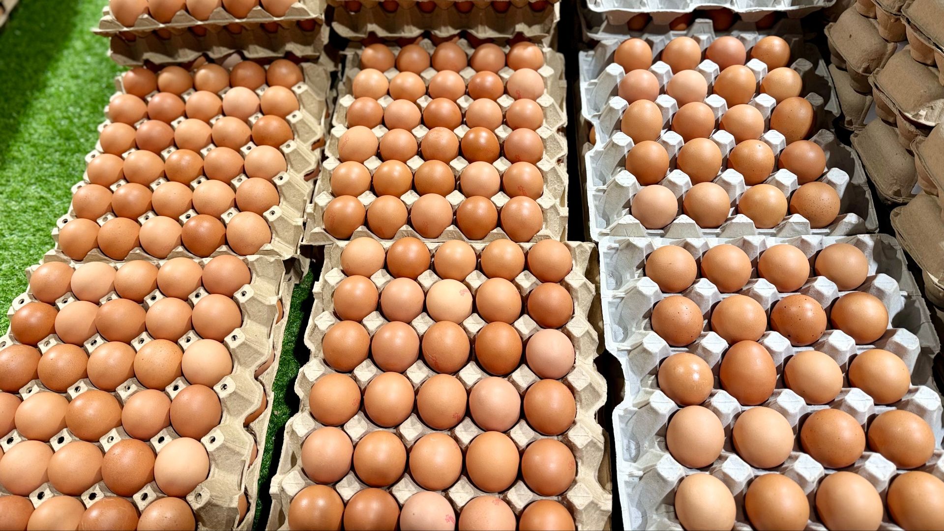 Fresh brown eggs neatly arranged in trays at a market in Melbourne, Australia.