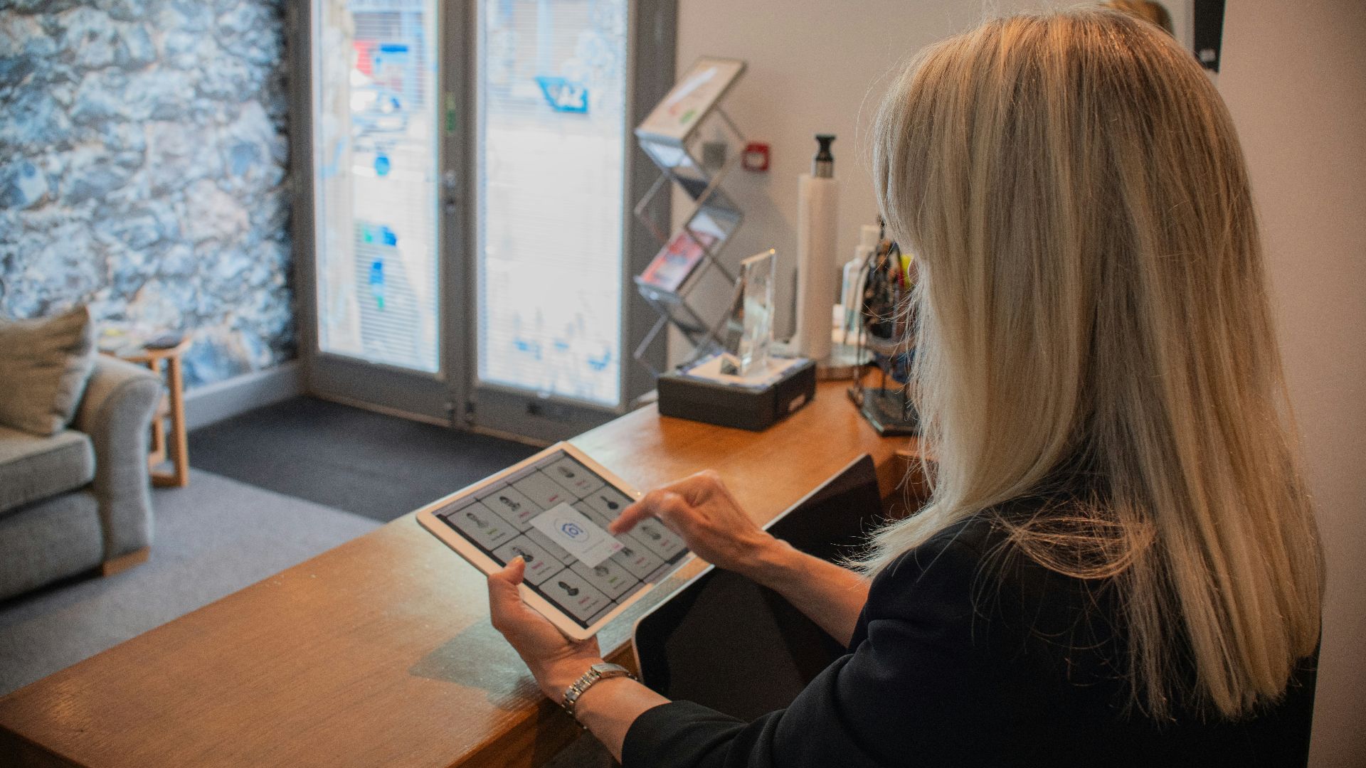 Woman using a tablet at a reception desk