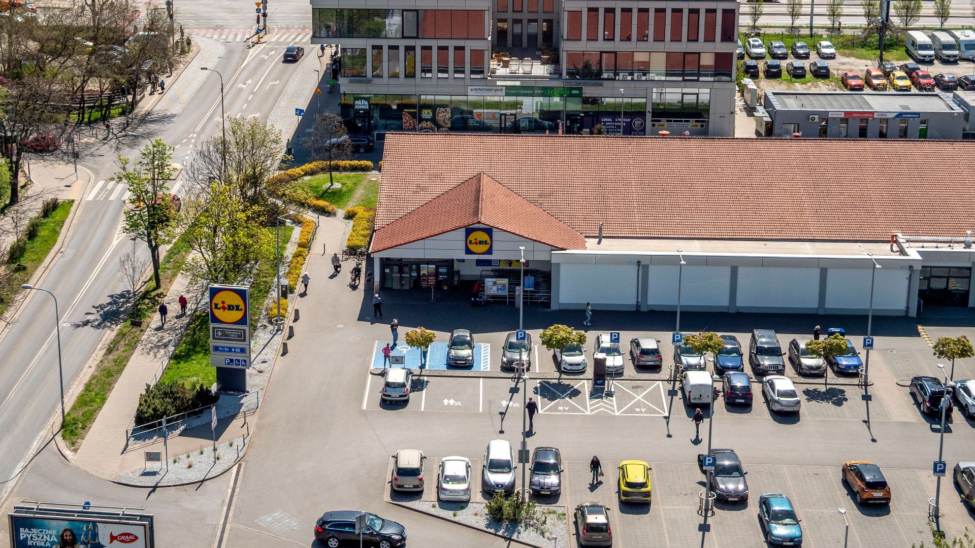 Aerial view of Wrocław's urban landscape highlighting a supermarket and streets.
