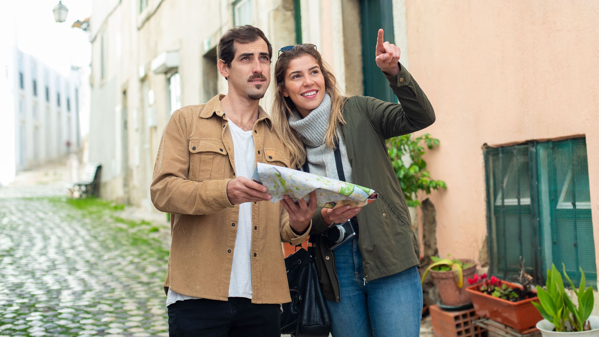 Happy couple exploring a charming European city street with a map. Perfect travel inspiration.