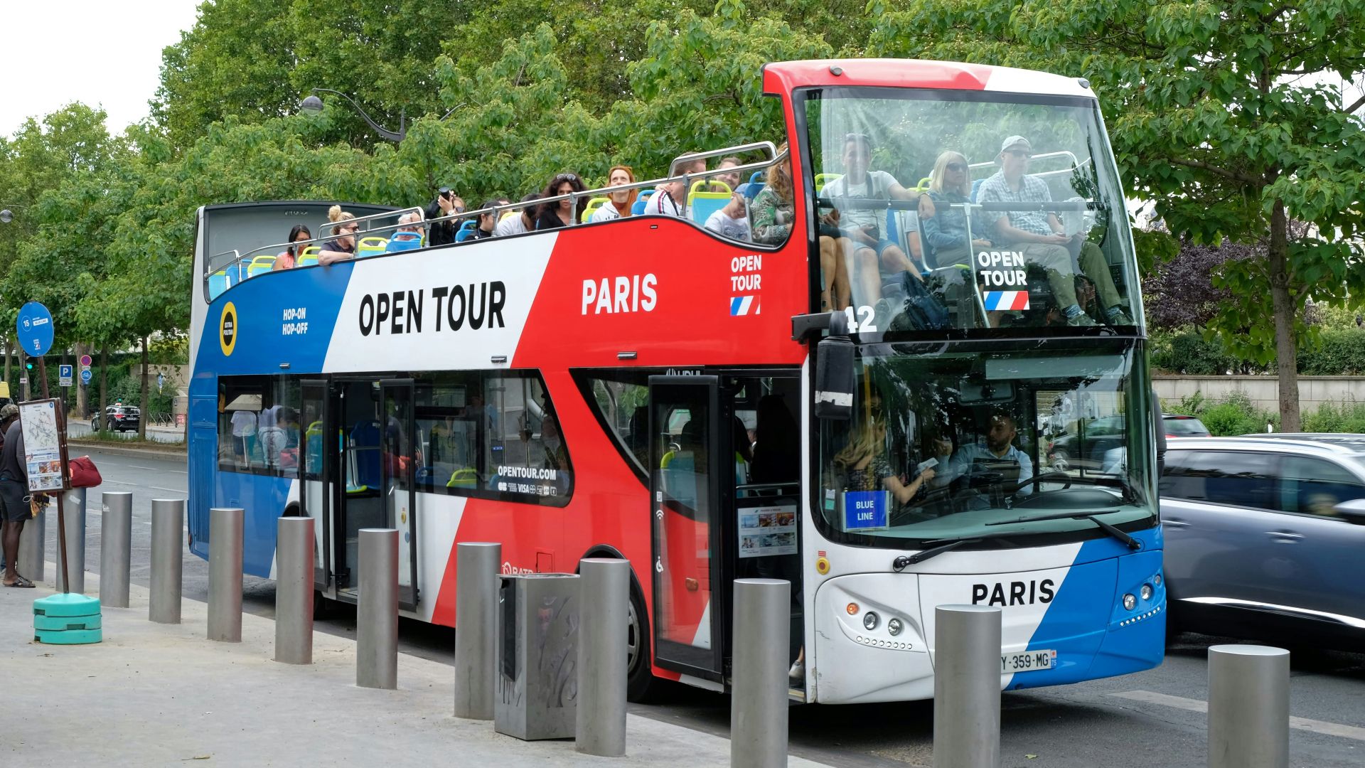 Double-decker open tour bus in paris with passengers