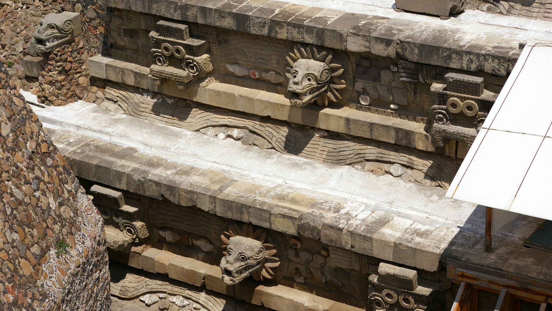 Teotihuacan - Temple of the Feathered Serpent - view of the architectural detail to the left of the steps of the pyramid, from above on the Adosada platform.