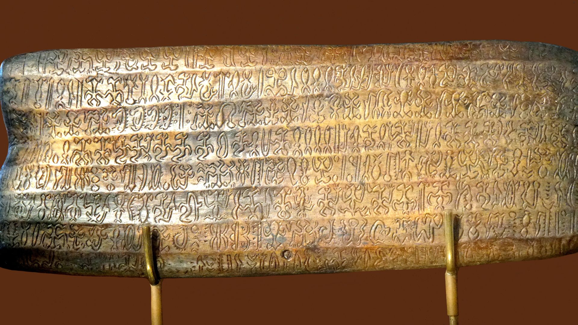 A reproduction of a rongorongo tablet, known as the 'Small Santiago' (text G), verso, at MAPSE Museum Rapa Nui in Hanga Roa, on Easter Island. 
Rongorongo inscriptions, this is a copy of the tablet called Mu'a Au Mingo Ata'i Hoa Au. It has 16 lines (8 on 
