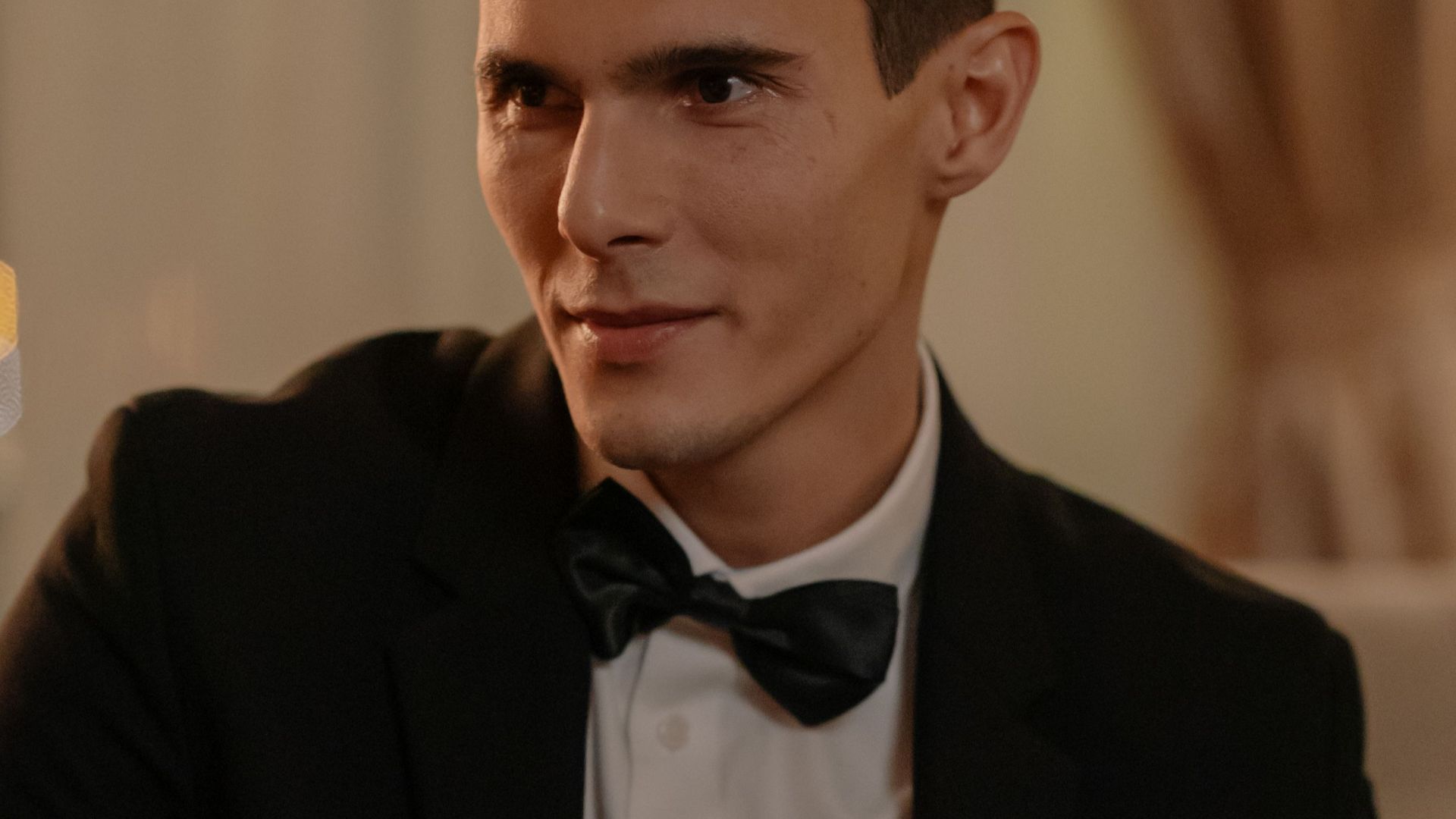 Sophisticated male portrait in a tuxedo at an indoor event. Perfect for lifestyle and fashion themes.