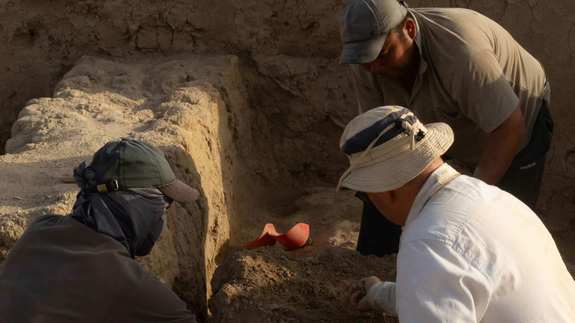 A group of men kneeling down next to each other