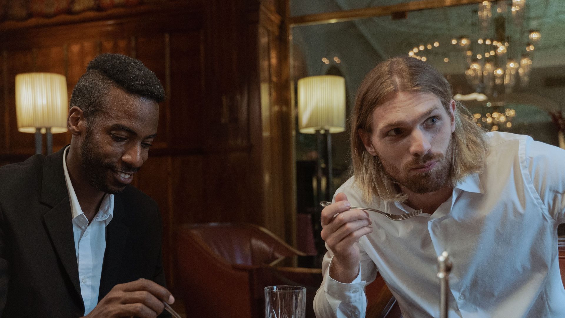 A stylish group enjoying a delicious meal in a sophisticated restaurant setting.