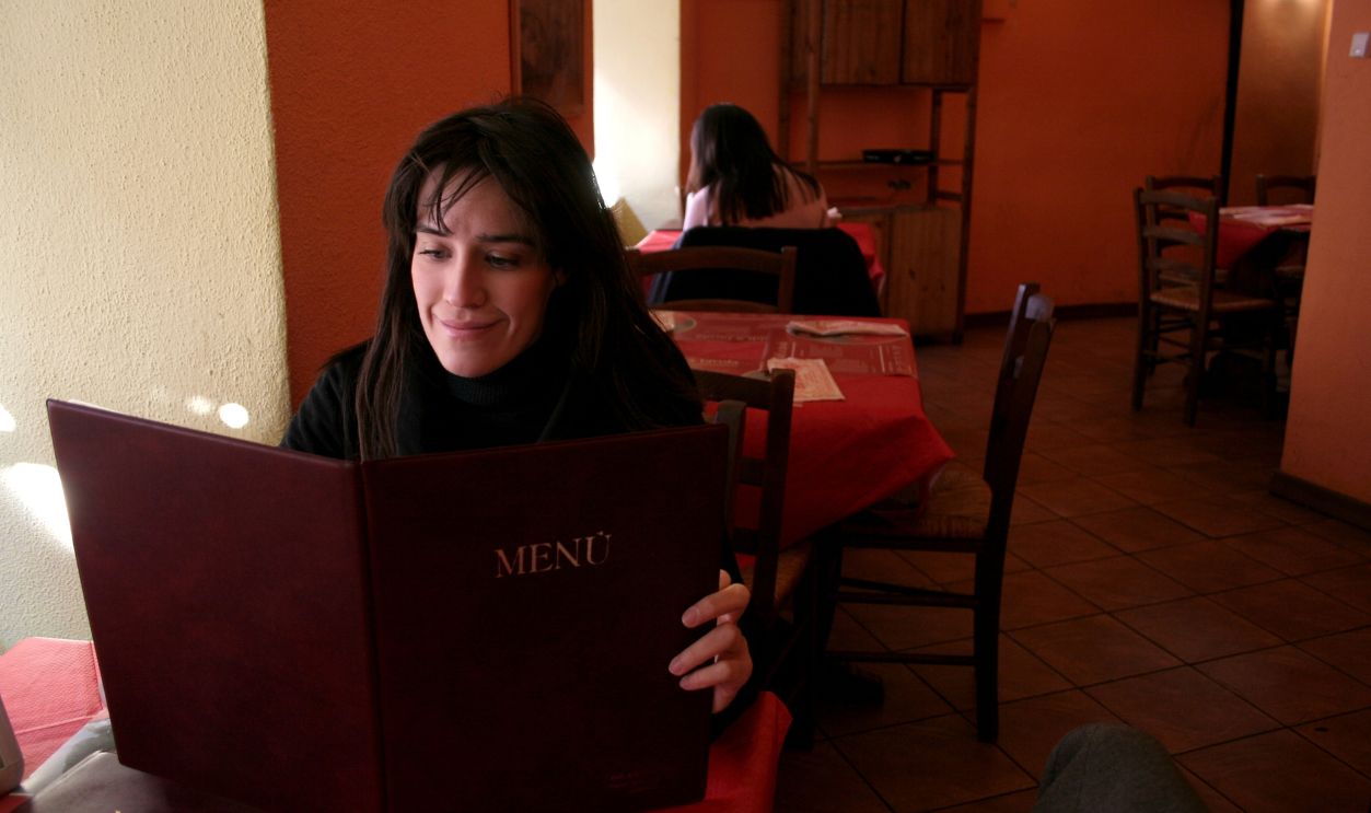 a woman at restaurant with a list