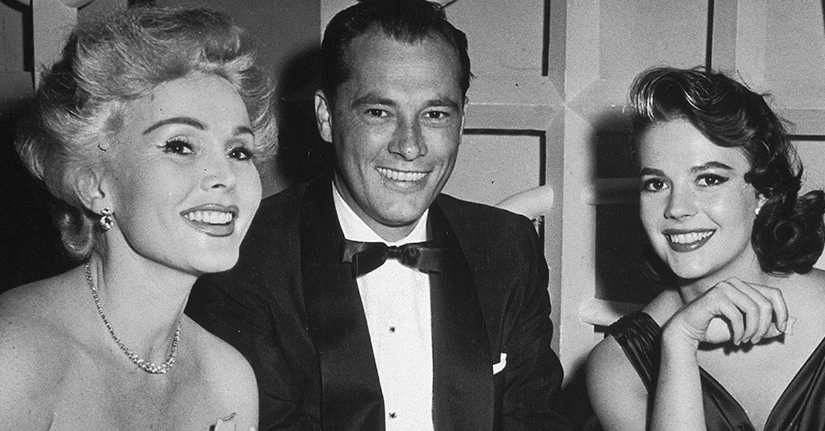 13th June 1957, Hungarian-born actor Zsa Zsa Gabor, hotel heir Conrad 'Nicky' Hilton (926 - 1969), and American actor Natalie Wood (1938 - 1931) at Mike Romanoff's Restaurant. They had been attending the premiere of the film 'Island in the Sun.'