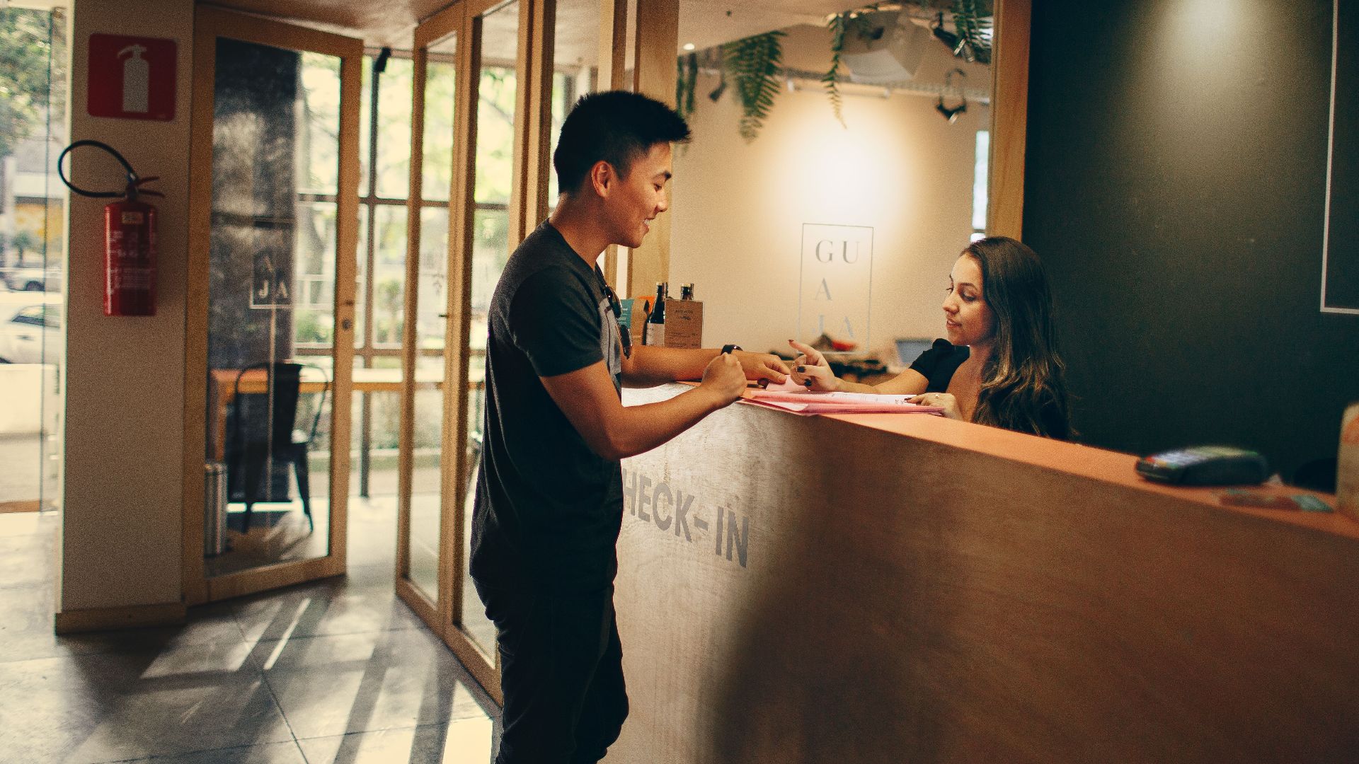 A customer checks in at a hotel reception desk in Belo Horizonte, Brazil.