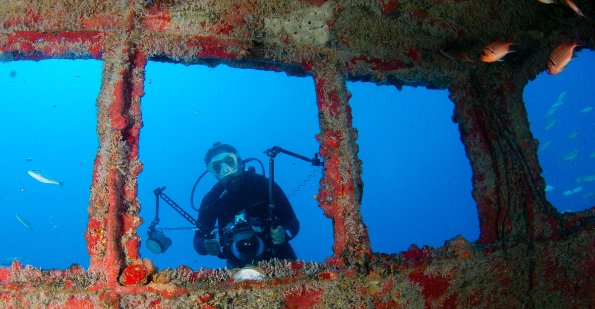 underwater-photograph-of-a-diver-with-red-wreck
