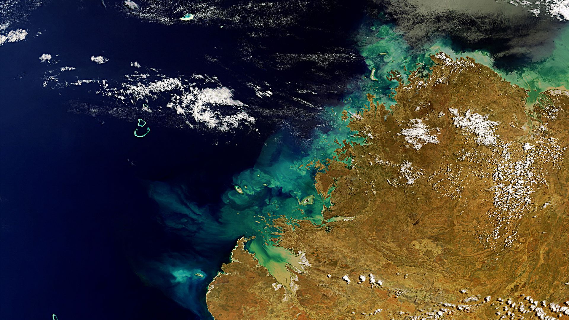 Western Australia’s Kimberley region, with a coastline along the Timor Sea, is pictured in this Envisat image. Off the coast in the lower left we can see a group of three coral reefs, known as the Rowley Shoals. Near the centre of the image is King Sound 