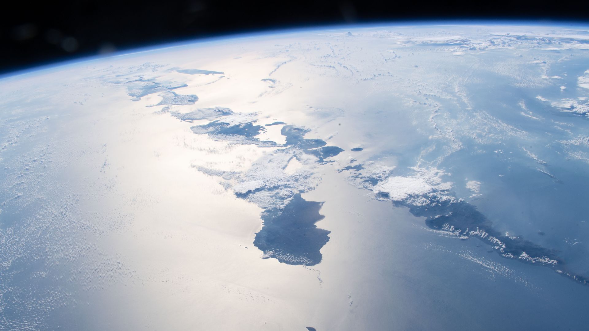 Just a few of the thousands of volcanic islands that make up the nation of Indonesia are pictured as the International begins an orbital pass over the Timor Sea after crossing western Australia.