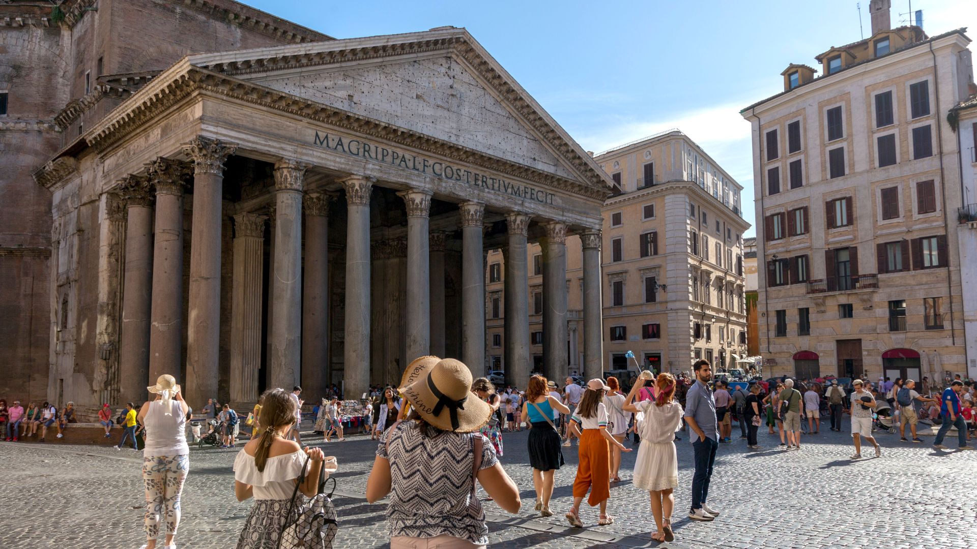 A vibrant scene of tourists visiting the iconic Pantheon in Rome, Italy, on a sunny day.