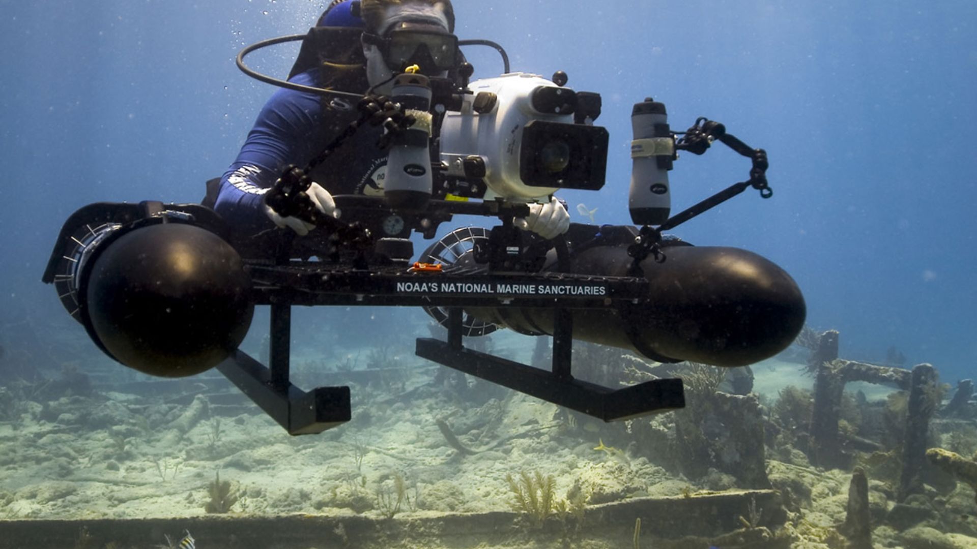 A NOAA archaeologist photographs a wreck site in Florida Keys National Marine Sanctuary using specially a constructed sled mounted with a high-resolution camera.