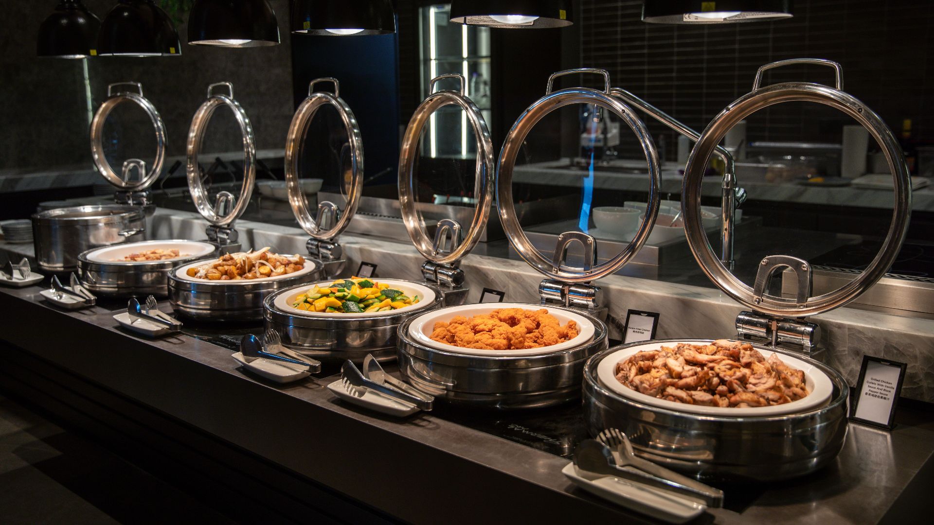 A stylish buffet setup featuring a variety of dishes under chic lighting.