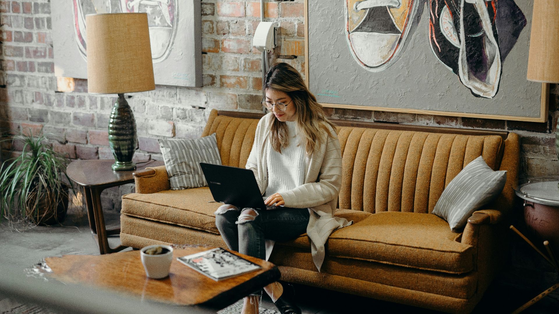 woman using laptop while sitting on chair