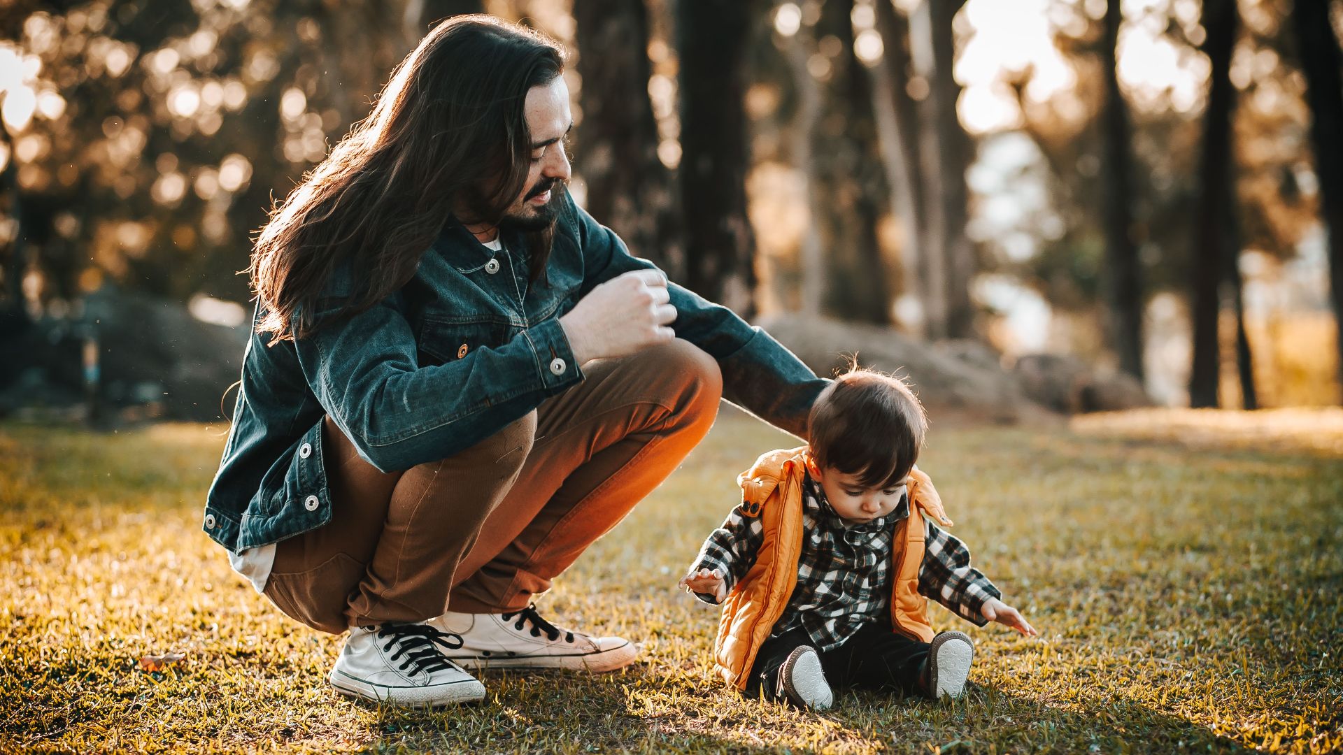 A heartfelt capture of a father playing with his child in a sunlit autumn park.