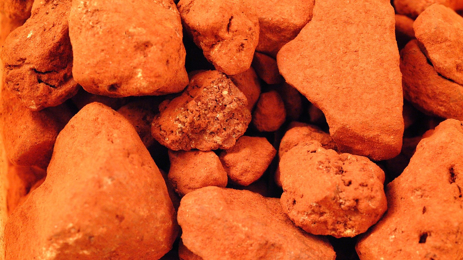 Hematite, Fe2O3 (iron oxide), is an important ore of iron and it's blood red color (in the powdered form) makes it a common pigment. Crystals of hematite are rare; fine grained masses or powdered forms are more common. Hematite may have a silvery black me